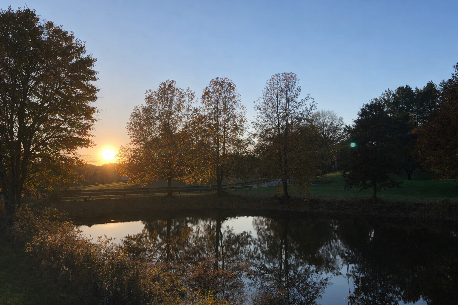 Autumn sunset reflected in the Spring Meadows community pond